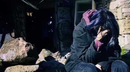 Sad sitting woman whose house was destroyed Badly in the war