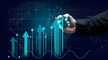 Virtual holographic chart of investments, growth of business indicators, increase in profits and a male hand on a dark blue background